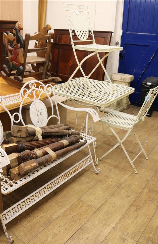 A four piece white painted garden suite, consisting of a square topped table, a bench and a pair of armchairs W.76cm, W.113cm (bench)